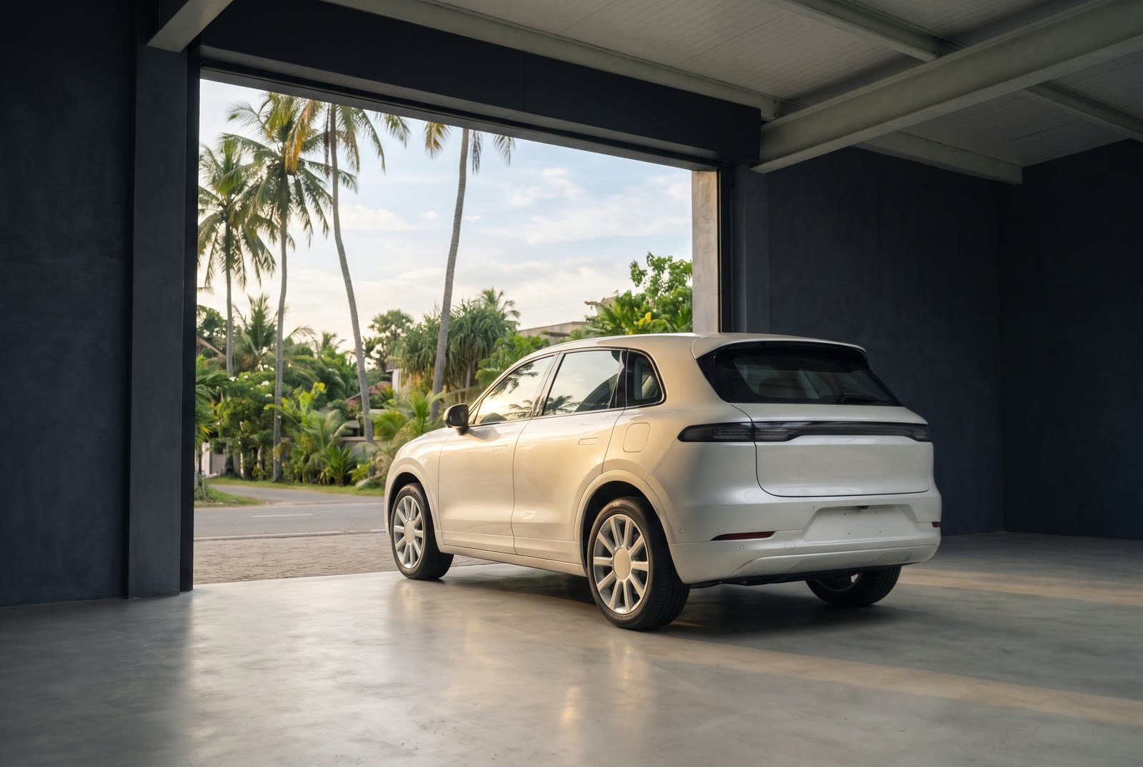 A white SUV rolling out of the showroom into warm afternoon light and palm trees